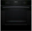 Black oven with digital display on a black background