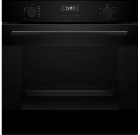 Black oven with digital display on a black background