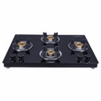 A slim black 4 burner gas stove with a toughened glass top and brass burners.