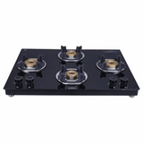 A slim black 4 burner gas stove with a toughened glass top and brass burners.